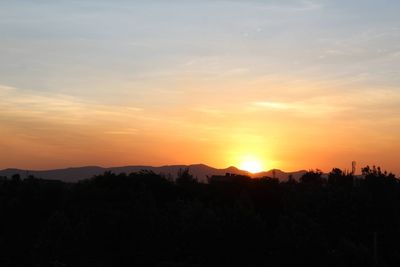 Scenic view of silhouette landscape against sky during sunset