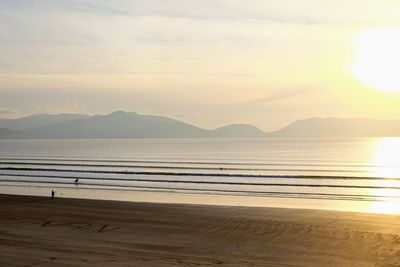 Scenic view of beach against sky during sunset