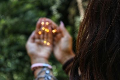 Close-up portrait of woman holding leaf