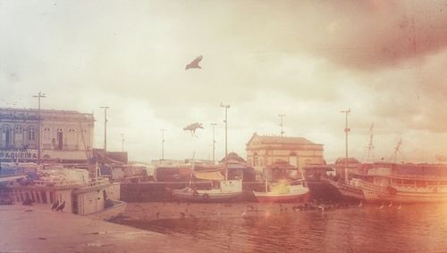 View of harbor against cloudy sky