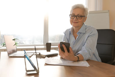 Portrait of doctor working at desk in office