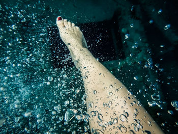 Low section of young woman in swimming pool