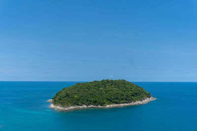 The landscape of the isolated island in the middle of the deep blue ocean clear sky as background
