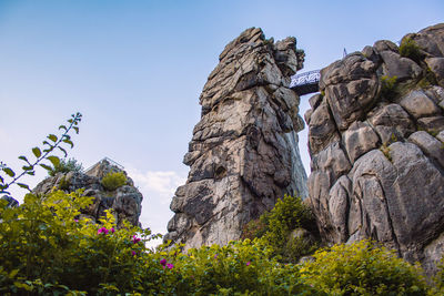 Low angle view of rock formation against sky