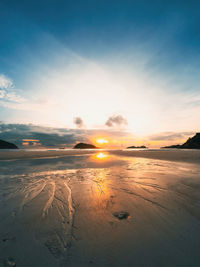 Scenic view of beach against sky during sunset