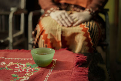 Midsection of woman sitting at home