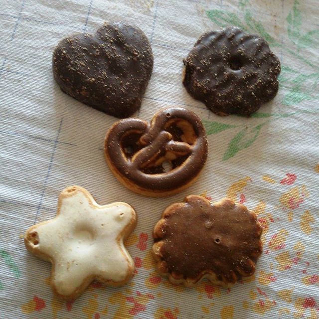 indoors, still life, close-up, table, animal representation, food and drink, food, brown, art and craft, creativity, sweet food, art, cookie, high angle view, human representation, no people, freshness, wood - material, baked, anthropomorphic face