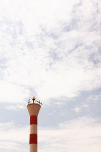 Low angle view of building against cloudy sky