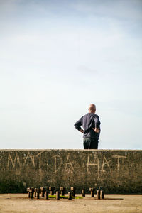 Man standing on field against sky