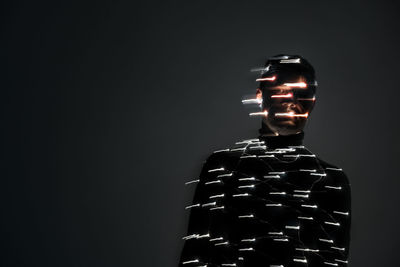 Close-up of illuminated lighting equipment against black background