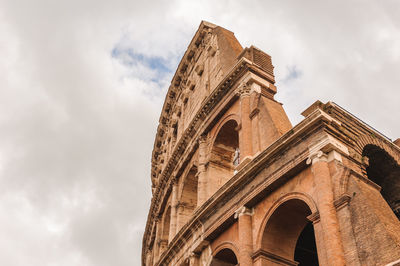 Low angle view of historical building against cloudy sky