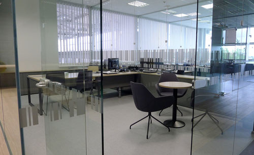 Empty chairs and tables on tiled floor