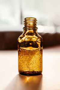 Pipette with cosmetic oil in a brown bottle with bubbles