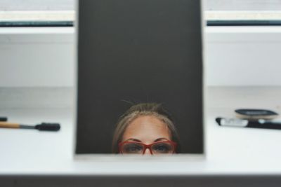 Close-up of woman reflecting in mirror