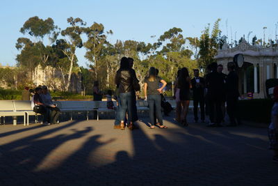 People in town square against sky