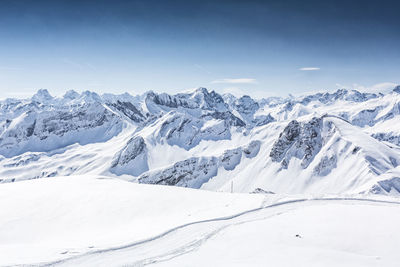 Scenic view of snowcapped mountains against sky