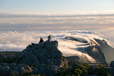 People on table mountain against cloudscape