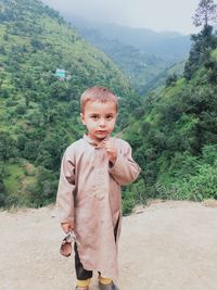 Portrait of boy standing on mountain