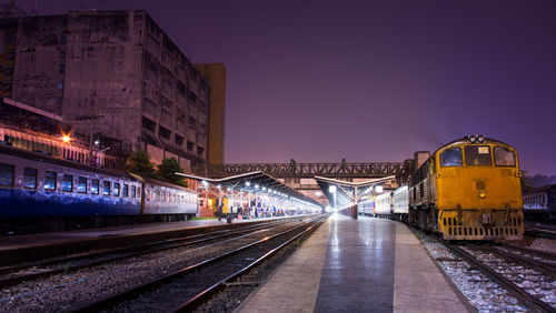 Train at railroad station platform at dusk