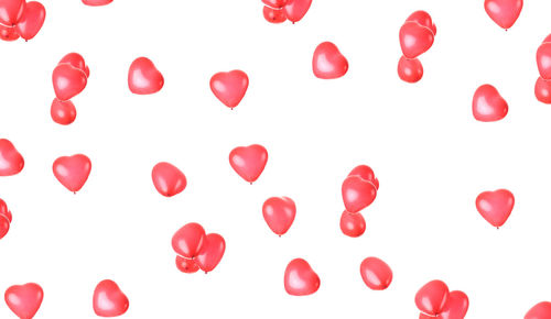 Close-up of red balloons against white background
