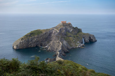 Scenic view of rock formation in sea against sky