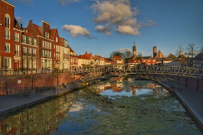 Bridge over river with buildings in background