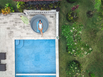 Aerial view of attractive woman near the pool at resort