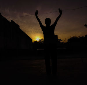 Silhouette man standing against sky during sunset