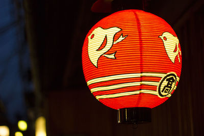 Close-up of illuminated lantern hanging on wall