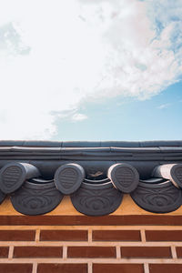 Low angle view of metal railing against sky