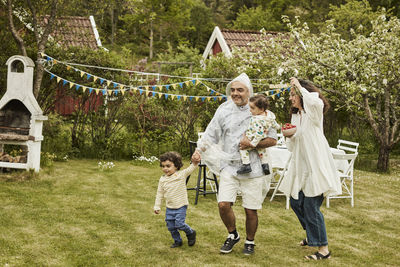 Happy family with kids in garden