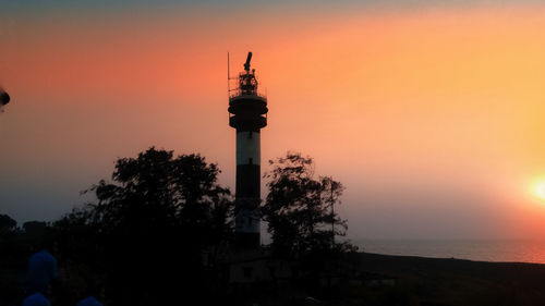 Silhouette of building against sky during sunset