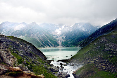 Scenic view of waterfall against sky