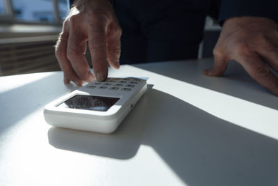 Hand of businessman using calculator on desk in office