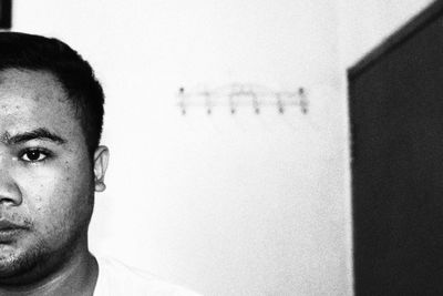 Portrait of young man against wall