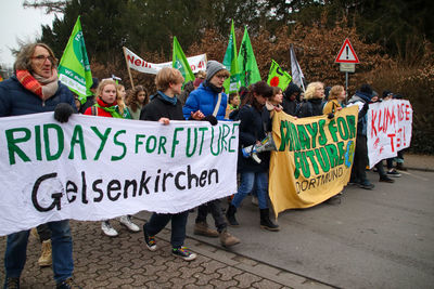 Close-up of people protesting on street