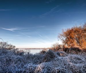 Scenic view of snow covered field against sky