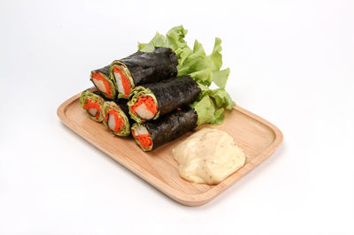 High angle view of dessert in plate against white background