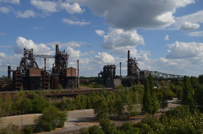 View of factory against cloudy sky