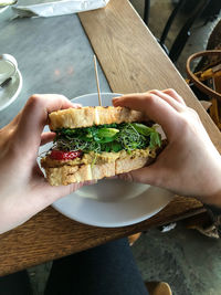 Cropped hand of person holding food