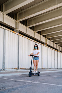 Full length of woman riding bicycle