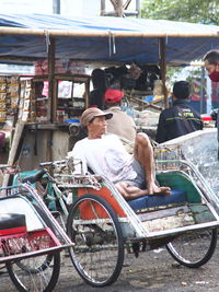 People riding bicycle at market