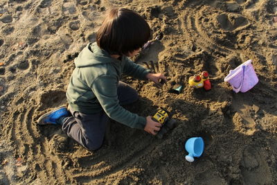 Boy playing with toy on beach