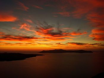 Scenic view of sea against dramatic sky during sunset