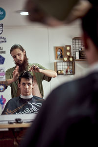 A barber cutting the hair of a young boy