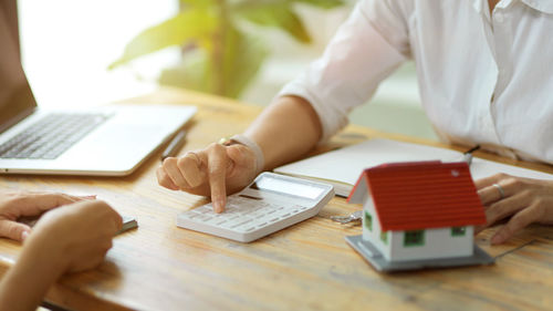 Midsection of man using laptop on table