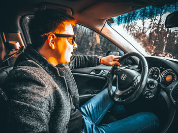 Man sitting in car