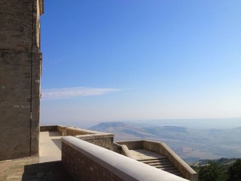 Built structure on mountain against clear blue sky