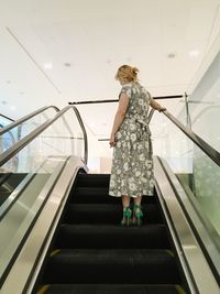 Rear view of young woman walking on staircase