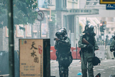 Full length of man painting on street in city